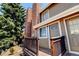 Exterior view of townhome with deck and brick chimney at 17102 E Baltic Dr # F, Aurora, CO 80013