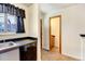 Kitchen features sink, dishwasher and access to a small bathroom at 17102 E Baltic Dr # F, Aurora, CO 80013