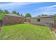 Expansive backyard view showcases a well-manicured lawn, storage shed, and neighboring brick home at 2065 Leyden St, Denver, CO 80207
