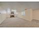 Spacious basement featuring a vintage fireplace with brick surround and ample carpeted space at 2065 Leyden St, Denver, CO 80207