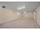 Finished basement showcasing ample open space with carpet and doorway, ideal for recreation at 2065 Leyden St, Denver, CO 80207