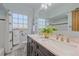 Bright bathroom featuring a double vanity, neutral countertops, and a window for natural light at 2065 Leyden St, Denver, CO 80207