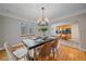 Bright dining room with hardwood flooring and an open view into the modern kitchen at 2065 Leyden St, Denver, CO 80207