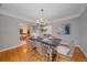 Bright dining room with hardwood floors, modern chandelier, and seating for six at 2065 Leyden St, Denver, CO 80207