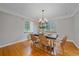 Elegant dining room with hardwood floors, a modern chandelier, and views into the kitchen at 2065 Leyden St, Denver, CO 80207