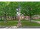 Charming Tudor home with brick exterior, manicured lawn, and mature trees at 2065 Leyden St, Denver, CO 80207
