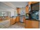 Open kitchen with breakfast bar that adjoins a dining area with wicker chairs at 2065 Leyden St, Denver, CO 80207