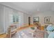 Bright living room with hardwood floors and neutral walls leads to an adjacent dining area at 2065 Leyden St, Denver, CO 80207