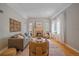 Bright living room features fireplace, hardwood floors, and neutral paint scheme at 2065 Leyden St, Denver, CO 80207