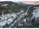 Picturesque aerial view of a mountain community nestled among snow-covered pines and peaks at 6365 Highway 9, Breckenridge, CO 80424