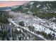 Expansive aerial view of a mountain valley with snow-covered meadows, roads, and scattered homes at 6365 Highway 9, Breckenridge, CO 80424
