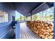 Mountain cabin deck featuring woodpile and scenic views of the surrounding trees at 6365 Highway 9, Breckenridge, CO 80424