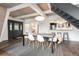Modern dining area with gray table, seating for six, and an A-frame ceiling at 6365 Highway 9, Breckenridge, CO 80424