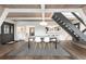 Open-concept dining area with hardwood floors, beamed ceilings and an eye catching staircase at 6365 Highway 9, Breckenridge, CO 80424