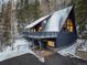 Charming A-frame home featuring a metal roof, large windows, and a spacious deck, set in a snow-covered mountain landscape at 6365 Highway 9, Breckenridge, CO 80424