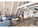 Open living area with a large grey sofa and a dining space with white modern chairs at 6365 Highway 9, Breckenridge, CO 80424