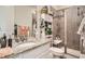 Bathroom featuring a granite countertop, sink, toilet, and tiled shower with a glass door at 16043 Fillmore St, Thornton, CO 80602