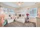 Charming ' bedroom with a whimsical playhouse bed frame, plenty of natural light and playful decor at 16043 Fillmore St, Thornton, CO 80602