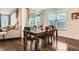 Dining room with a large table, hardwood floors, and natural light at 16043 Fillmore St, Thornton, CO 80602