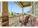 View from the front porch, with a cozy chair and a glimpse of the neighborhood street at 16043 Fillmore St, Thornton, CO 80602