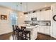 Kitchen island with granite countertop, pendant lighting, and seating at 16043 Fillmore St, Thornton, CO 80602