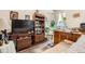 Cozy living area with a TV, shelving, bar seating, and comfortable seating with a view from the window at 16043 Fillmore St, Thornton, CO 80602
