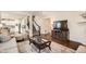 Open living space with hardwood floors, a decorative fireplace, and ample seating at 16043 Fillmore St, Thornton, CO 80602