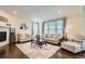 Bright living room with hardwood floors and neutral decor, offering a comfortable and inviting space at 16043 Fillmore St, Thornton, CO 80602
