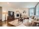 Cozy living room featuring a fireplace, plush seating, and hardwood floors at 16043 Fillmore St, Thornton, CO 80602