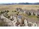 Aerial view of townhomes nestled in a natural setting with mountain views in the distance at 1747 High Plains Ct, Superior, CO 80027