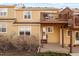 Backyard patio area with grass and an outdoor deck, attached to a tan-colored townhome at 1747 High Plains Ct, Superior, CO 80027