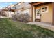 Backyard featuring green grass, landscaping, and exterior view of the townhome and stairs at 1747 High Plains Ct, Superior, CO 80027