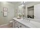 Bathroom with marble countertops, a large mirror, and in-bathroom laundry machines at 1747 High Plains Ct, Superior, CO 80027