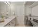 Light bathroom with white marble countertops, laundry machines, and modern fixtures at 1747 High Plains Ct, Superior, CO 80027