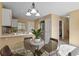 Cozy dining area features a glass table, modern light fixture, and stainless steel appliances in the adjacent kitchen at 1747 High Plains Ct, Superior, CO 80027