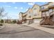 Exterior view of townhomes with private garages and a shared driveway in a quiet community at 1747 High Plains Ct, Superior, CO 80027