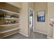 Hallway with decorative wall shelving with view to a balcony at 1747 High Plains Ct, Superior, CO 80027