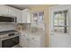 Bright kitchen featuring white cabinets, modern appliances, and a view to the outside at 1747 High Plains Ct, Superior, CO 80027