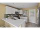 Bright kitchen boasts white cabinets, stainless steel appliances, and a stylish countertop at 1747 High Plains Ct, Superior, CO 80027