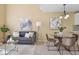 Comfortable living room connected to a dining area, featuring stylish furniture and decor at 1747 High Plains Ct, Superior, CO 80027