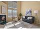 Bright living room featuring large windows, a fireplace, and stylish decor at 1747 High Plains Ct, Superior, CO 80027