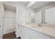 Bright bathroom featuring a large mirror, double sinks and white cabinets at 1385 Bloom St, Brighton, CO 80601