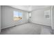 Bedroom featuring carpet, neutral paint, and three windows at 1385 Bloom St, Brighton, CO 80601