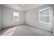 A carpeted bedroom with natural light coming from the two windows at 1385 Bloom St, Brighton, CO 80601
