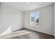 Bright bedroom with wood-look flooring and large window, offers a peaceful retreat at 1385 Bloom St, Brighton, CO 80601