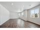 Bright, spacious living room features wood-look floors and multiple windows for natural light at 1385 Bloom St, Brighton, CO 80601