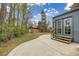 Backyard features a concrete patio, wooden steps, and well-manicured trees at 3230 Vance St, Wheat Ridge, CO 80033
