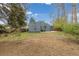 The backyard features newer siding, a concrete pad, green grass, and a wooden fence at 3230 Vance St, Wheat Ridge, CO 80033