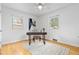 Bright bedroom features hardwood flooring, two windows, and a simple workstation at 3230 Vance St, Wheat Ridge, CO 80033