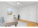 Bright bedroom features a ceiling fan, a wooden desk, and hardwood flooring at 3230 Vance St, Wheat Ridge, CO 80033